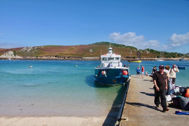 Ferry passengers arrive at Bar Quay on Bryher (Tresco in background)