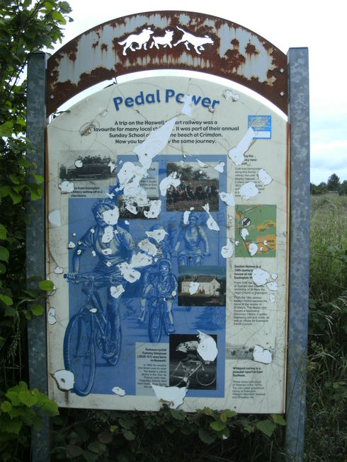 Infromation board commemorating Tommy Simpson.  Board is where the cycle track crosses Pesspool Lane
